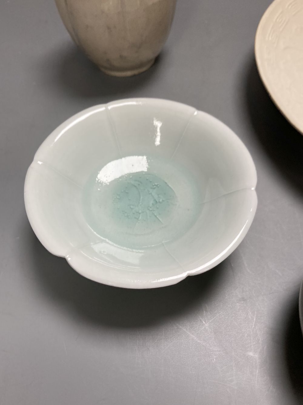 A Chinese Ding type dish, 21.5cm a similar lobed jarlet, possibly Yuan, a Qingbai style dish and another jar,